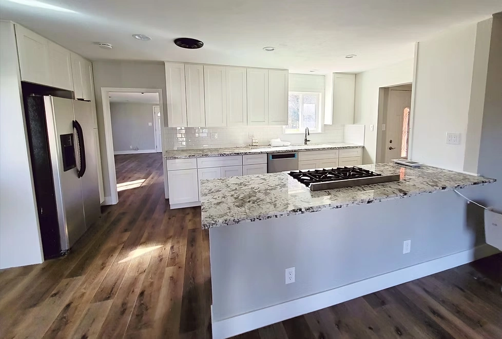 Kitchen Remodel. White shaker cabinets. Subway tile backsplash. Granite countertops. Luxury flooring.